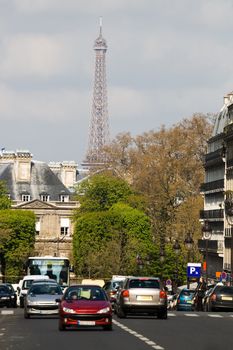 Street with cars in Paris, Latin quartal. Eiffel tower in background.