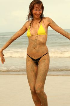 happy bikini girl posing on the beach