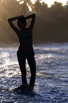 woman silhouette by sunset in the caribbean