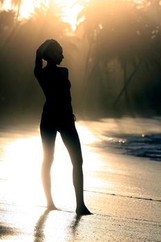 woman silhouette by sunset in the caribbean