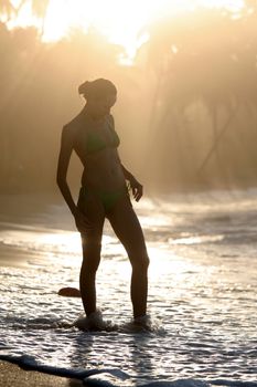 woman silhouette by sunset in the caribbean