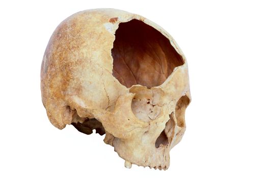 Old broken skull against white background