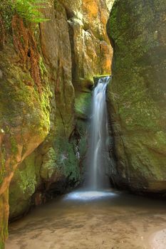 Waterfall in Aderspach sandstone rock city in Czech Republic