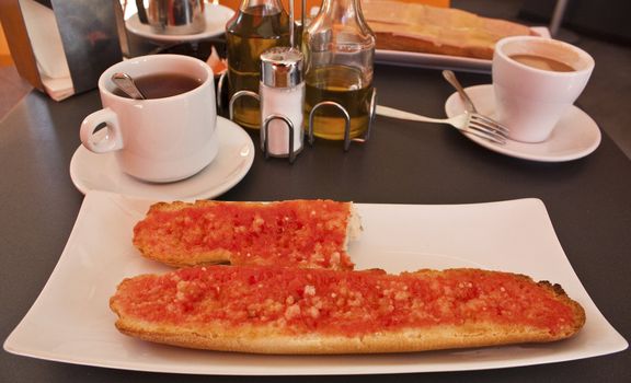 Breakfast in a cafeteria in Mediterranean Spain: tomato toast and coffee.