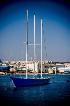 Small sized sailing boat in a blue lagoon