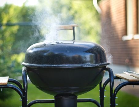 preparing food in a barbecue, outdoors, shallow DOF