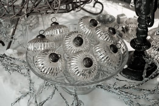 Antique silver Christmas ornaments decorate a timeless Christmas scene. 