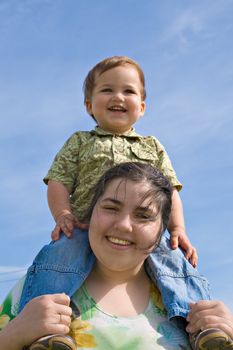 Woman holding her little child on back