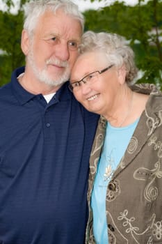 outside portrait of an elderly couple enjoying each others company