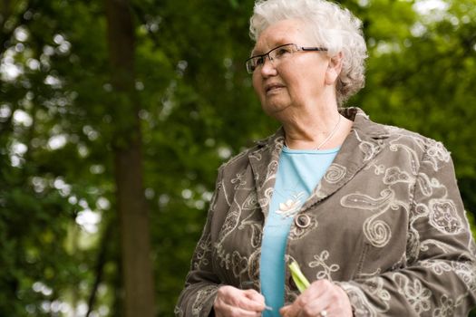 Outside portrait of an elderly woman standing and looking