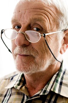 portrait of an elderly man with reading glasses