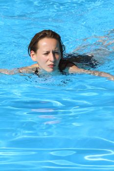 woman swimming in the pool by the hotel