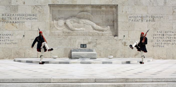 Athens, Greece - April 21, 2009: Evzones (presidential ceremonial guards) in front of the Unknown Soldier's Tomb at the Greek Parliament Building in Athens, opposite Syntagma Square. Evzones guard the Tomb of the Unknown Soldier, the Hellenic Parliament and the Presidential Mansion. They are also known locally as Tsoliades.