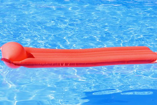 inflatable mattress swimming in the pool by the sun