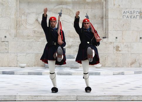 Athens, Greece - April 21, 2009: Evzones (presidential ceremonial guards) in front of the Unknown Soldier's Tomb at the Greek Parliament Building in Athens, opposite Syntagma Square. Evzones guard the Tomb of the Unknown Soldier, the Hellenic Parliament and the Presidential Mansion. They are also known locally as Tsoliades.