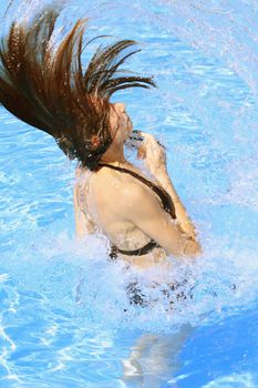 woman takes a bath in the swimming pool