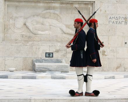 Athens, Greece - April 21, 2009: Evzones (presidential ceremonial guards) in front of the Unknown Soldier's Tomb at the Greek Parliament Building in Athens, opposite Syntagma Square. Evzones guard the Tomb of the Unknown Soldier, the Hellenic Parliament and the Presidential Mansion. They are also known locally as Tsoliades.