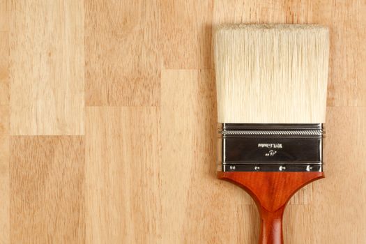 Paint Brush on a Wood Surface with Copy Room.