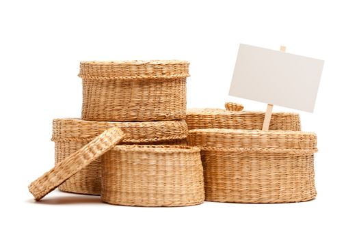 Various Sized Wicker Baskets with Blank Sign Isolated on White.