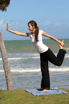Balancing and yoga exercises on the beach