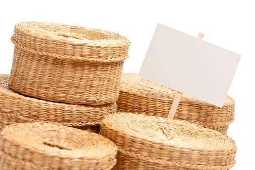 Various Sized Wicker Baskets with Blank Sign Isolated on White.
