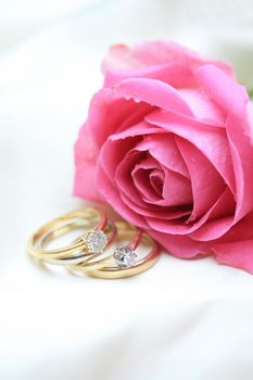 Double diamond wedding set and a pink rose - perfect for a same sex wedding item