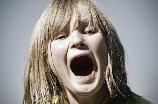 great cross processed style miage of a young girl mouth open yelling