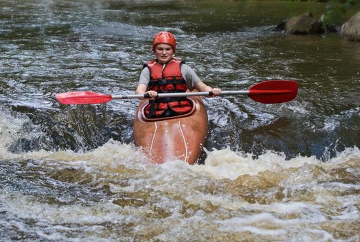 great image of a teenager girl white water kayaking