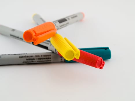 Ultra Fine Tipped Office Marker Pens on White Background in Red Orange Green and Yellow