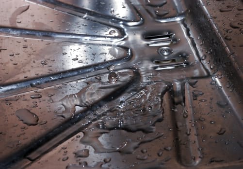 Rainwater running along galvanized steel 