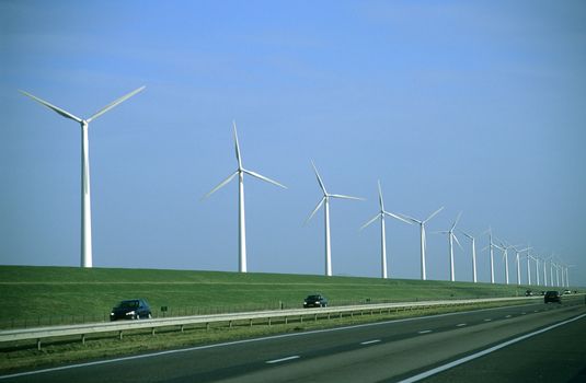 Modern windmills, or wind turbines, dot the lowland countryside of the Netherlands. 