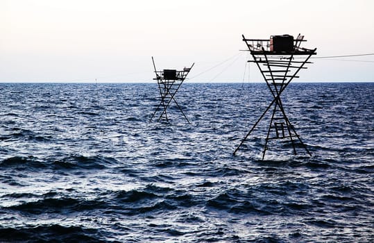 Fisherman�s towers and nets on the bright blue sea.