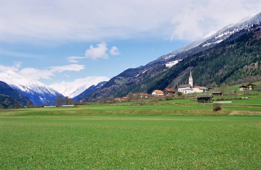 A tiny rural village sits below the snow line in the Austrian Alps.