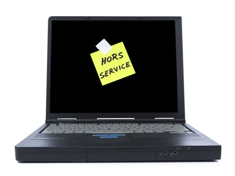 Black laptop with a sticky note in french meaning Out of Service. Isolated on white.