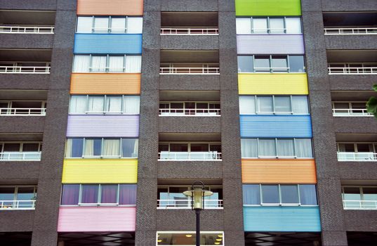 A modern condominium building in Amsterdam is decorated with colourful panels.