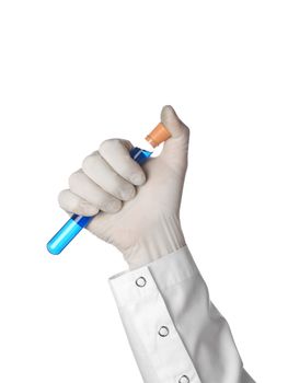 A doctor's hand holds a test tube pressing the cap on with his thumb.