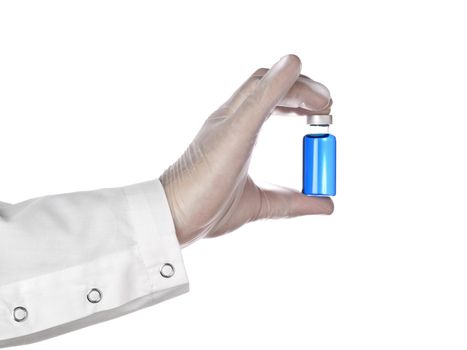 A doctor holds a vial full of blue liquid with his latex gloves on. Isolated on white.