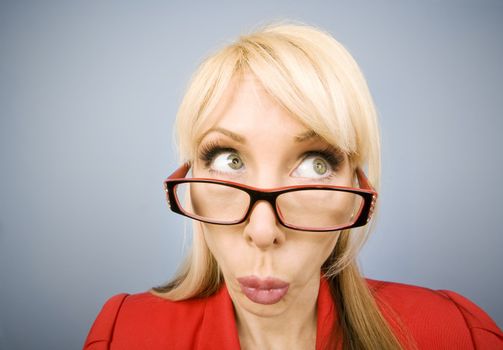 Woman in red pursing her lips and making a funny face