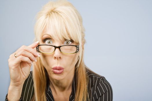 Businesswoman looking over the top of her glasses