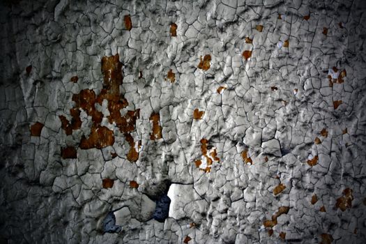 peeling paint on the wall of an abandoned apartment building