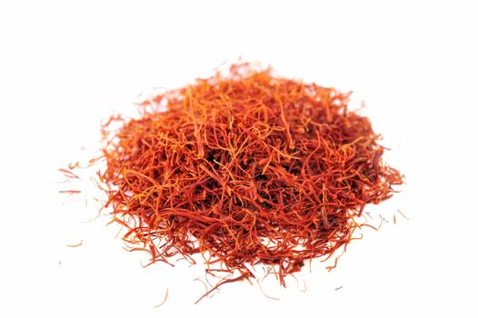 Handful of red saffron on a white background