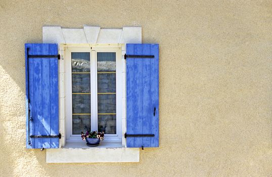 A Provencial window with the tradional blue shutters, Gigondas, France.