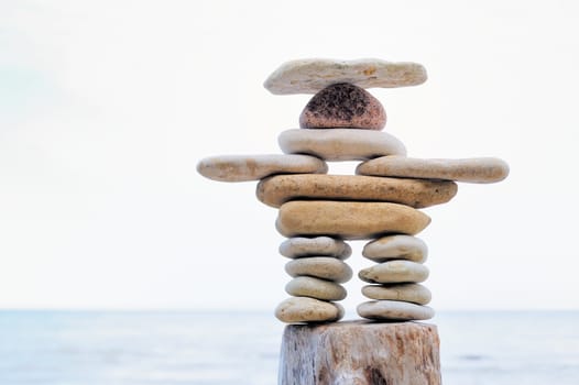 Symbolic figurine is made of pebbles on the shore