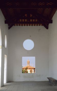 An Abstract view of Barcelona, Spain from a building in Monjuic Park. The circle and square windows overlook the city.