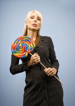Woman holding a big colorful lollipop