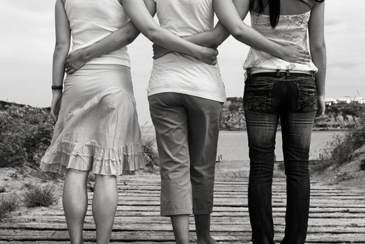 Three young girls walking to the beach