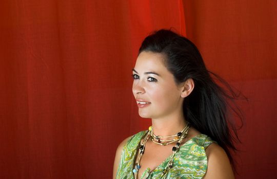 Young and beautiful woman portrait on a red background