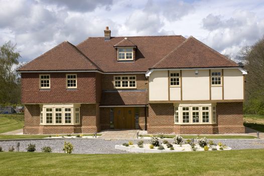 A big detached home with a cloudy sky