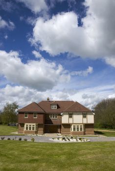 A big detached home with a cloudy sky