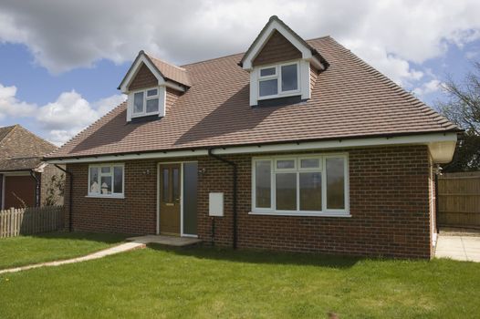 A small house with a front lawn